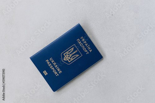 Blue passport of Ukraine lies on hryvnia photo