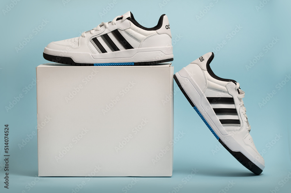Belgrade, Serbia - May 11, 2022. New Adidas tennis shoes on white  background with package box. New Adidas Sneakers or trainers on blue  background. Men's sport footwear Stock Photo | Adobe Stock
