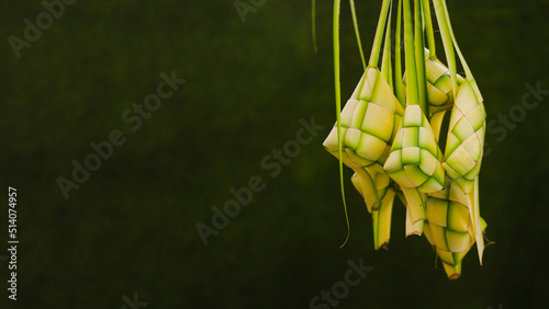 A group of empty Ketupat skin or ketupat pouch with copyspace and green background