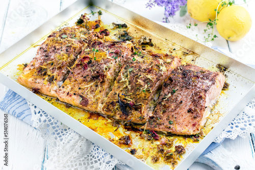 Traditional German salmon filet with herbs and spice served as close-up in a silver tray PRO05696
