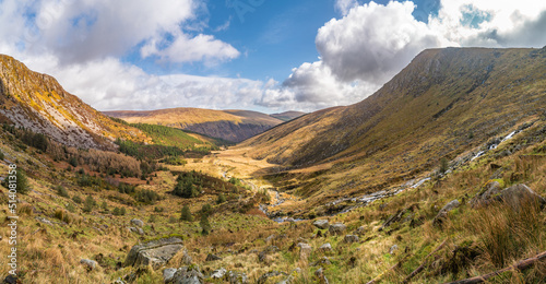 Panoramic view of Glenmalure valley during sunny day. It is U-shaped glacial valley in the Wicklow Mountains in Ireland. Base for accessing the mountain of Lugnaquilla. 