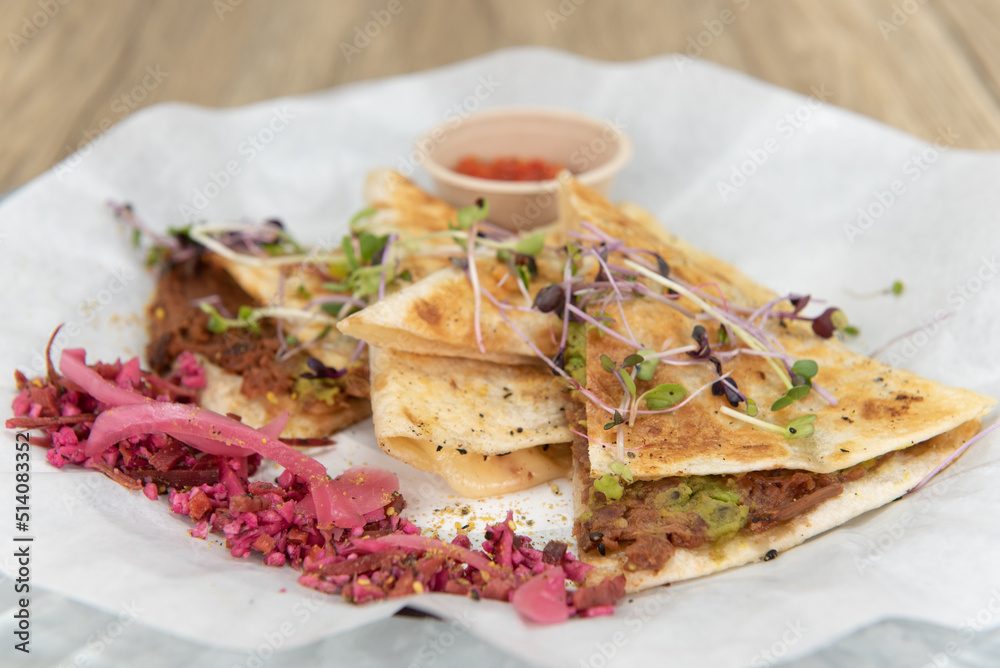 Nutritious cheese quesadilla with BBQ jerk jackfruit on a tortilla will start any day with a nutrional boost Nutritious cheese quesadilla with BBQ jerk jackfruit on a tortilla will start any day with a nutrional boost
