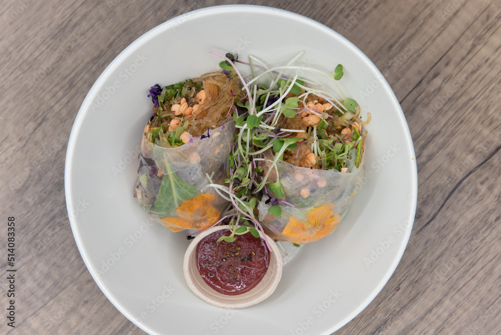 Vegetarian style spring roll, cut in half to show super green ingredients and a healthy dipping sauce for that nutrition conscious diet Vegetarian style spring roll, cut in half to show super green ingredients and a healthy dipping sauce for that nutrition conscious diet