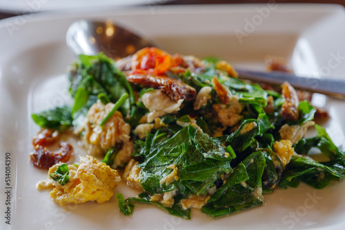 Stir-fried Malindjo Leaves with Egg serve on white plate.
