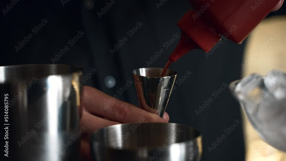 bartender prepares a cocktail in a bar, club. pours alcohol and syrups. uses ice and breaks ice bartender prepares a cocktail in a bar, club. pours alcohol and syrups. uses ice and breaks ice