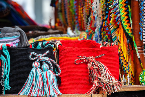 Street sale of hand made traditional Colombian mochilas and necklaces at Caldas Square in the center of the city of Popayan photo