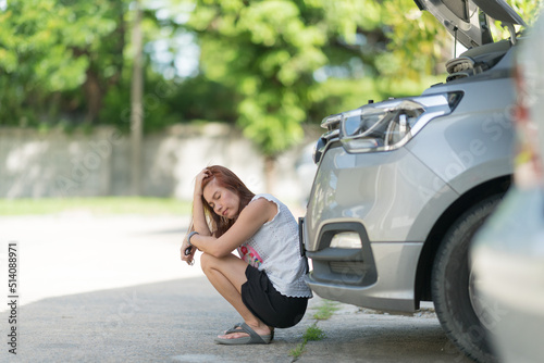  woman is sad because of a broken car
