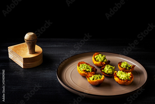 Green banana cups with avocado - dark background