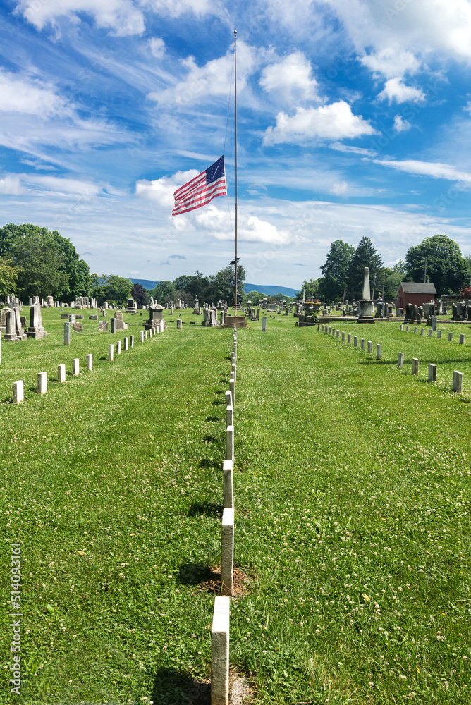 Fototapeta premium American flag is flown at half mast at the American War Cemetery in Charles Town, Virginia.