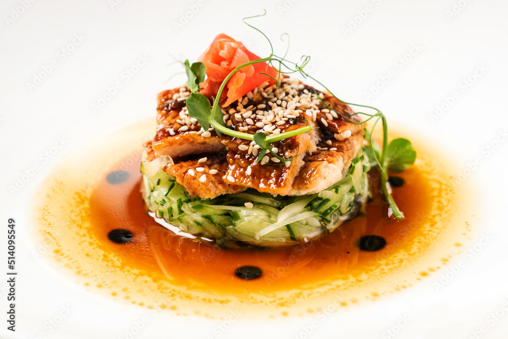 Fried eel with vegetables on the white plate Fried eel with vegetables on the white plate