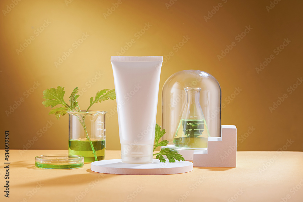 Front view of mugwort ( artemesia vulgaris ) decorated in petri dish glassware white podium cosmetic jar and brown background Front view of mugwort ( artemesia vulgaris ) decorated in petri dish glassware white podium cosmetic jar and brown background