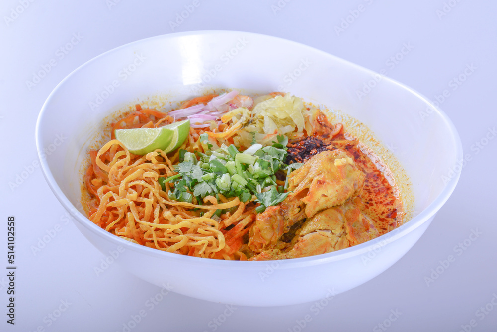 Thai spicy food, Egg noodle in chicken curry or name in thai is khao soi kai.noodles in soup cooked after the manner of the people of north Thailand on white background  with clipping path