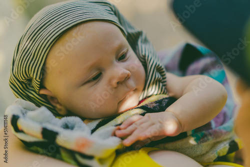 Cute 2 month old baby looking at his mother close up portrait. Summer vacation with newborn or infant baby.