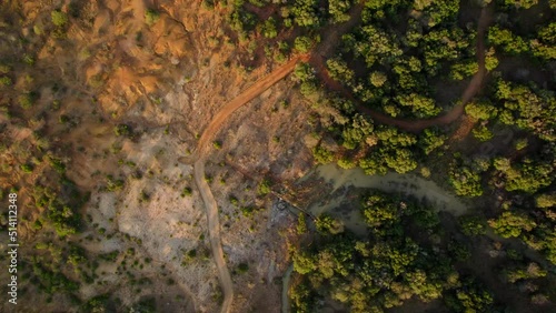 Aerial footage of deforested landscape next to forested one with a river full of life and biodiversity. Causes of climate change photo