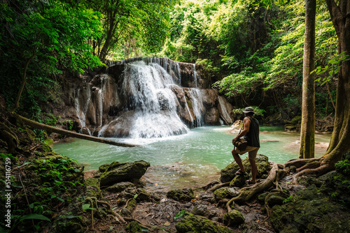 Valokuvatapetti Thai guy Asian man backpacker men enjoying beautiful emerald waterfalls green fo