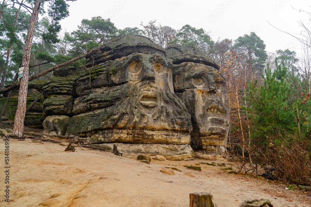 Heads carved into rock. Monument , history, nature, park.