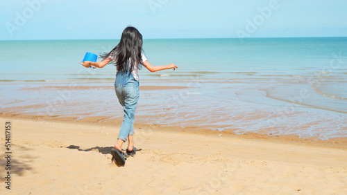 Running of teenager asian girl playing water outside on the beach together having fun enjoy freedom on summer vacation people lifestyle activity on weekend concept.