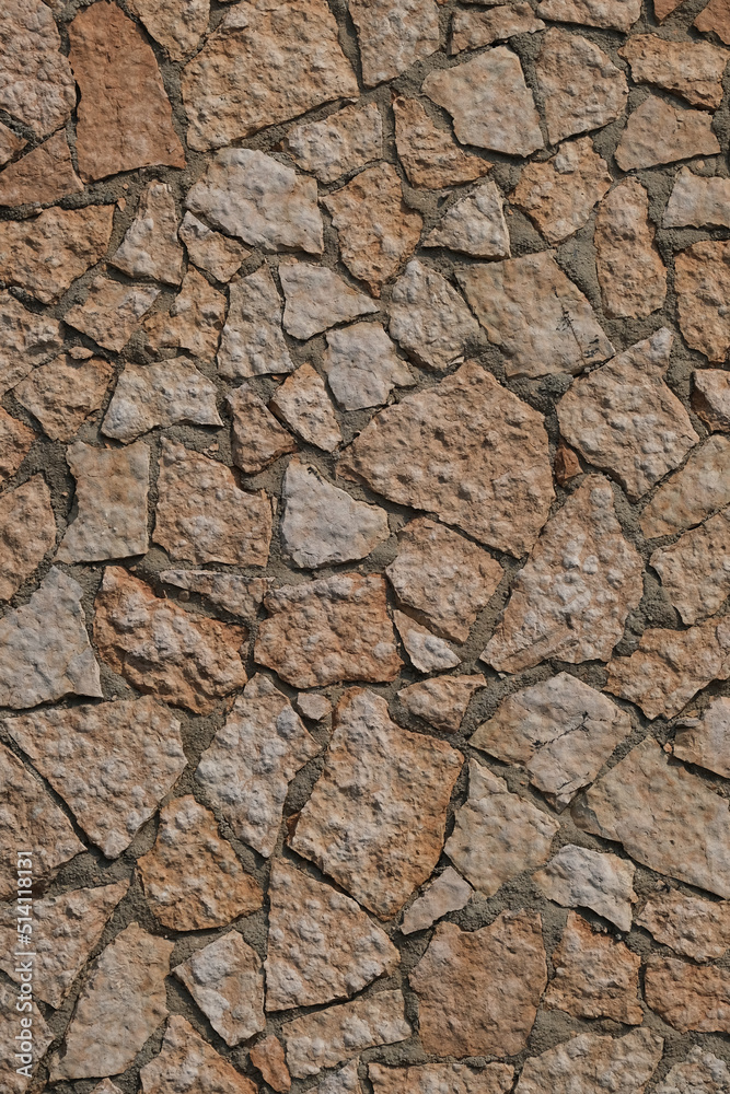 Facades marble stone wall. Pieces of pink marble on the wall. Texture stone on the facade of the house. Pattern of decorative marble stone wall surface. Facades marble stone wall. Pieces of pink marble on the wall. Texture stone on the facade of the house. Pattern of decorative marble stone wall surface.
