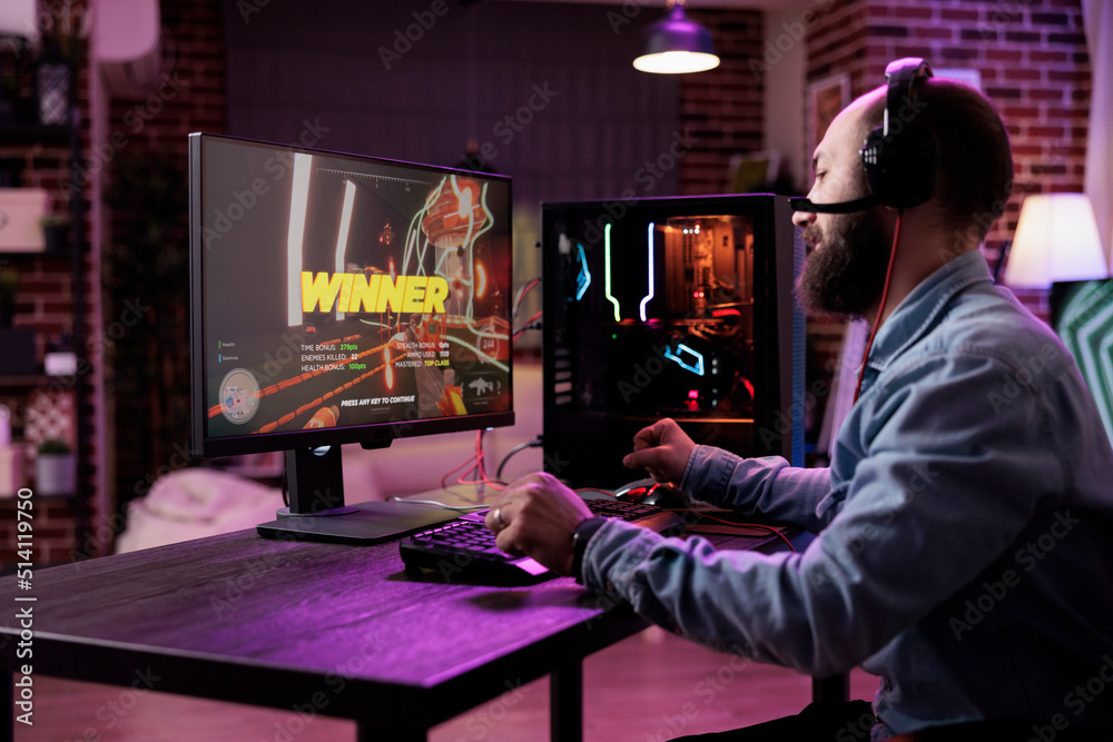 Young person winning action video games on computer, playing online gaming championship. Male player celebrating gameplay win, feeling happy about rpg tournament on modern computer.