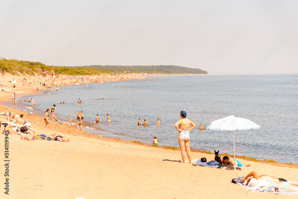 Vacation tourists at the beach in summer hot bright summer day.Klaipeda Lithuania June 24 2022.