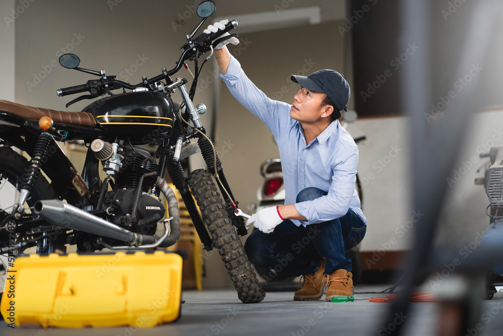 Mechanic check brake system on motorcycle brake reservoir in garage. Mechanic check brake system on motorcycle brake reservoir in garage.