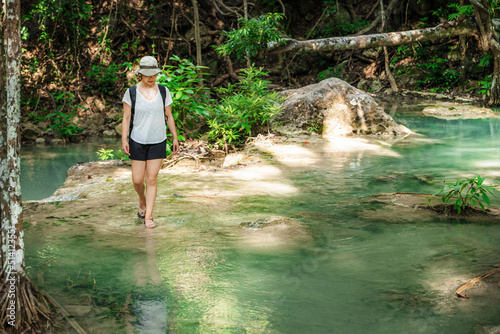 young cute Japanese girl Asian teen woman brunette portrait adult women mature enjoy beautiful emerald waterfalls mountains guide Thailand destinations at Erawan waterfall national park  Kanchanaburi.