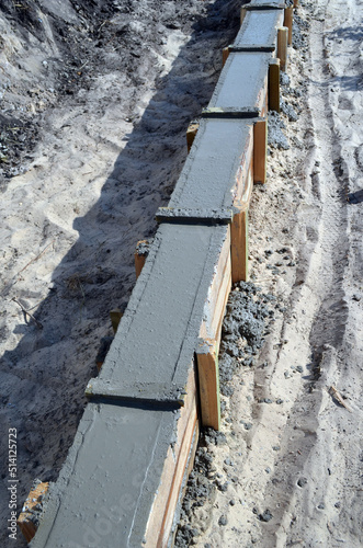 Timber formwork with metal reinforcement for pouring concrete and creating a solid foundation for a building or sauna. Construction process. © Sergey Kamshylin
