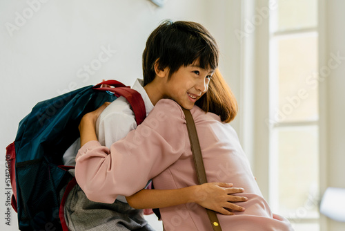Mother prepares to send her son to school.