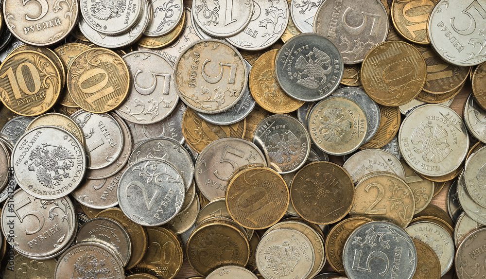 Russian coins rubles, top view. Financial sanctions and default, the collapse of the ruble and the economy due to the military invasion. Idea for background or banner for economic news Russian coins rubles, top view. Financial sanctions and default, the collapse of the ruble and the economy due to the military invasion. Idea for background or banner for economic news