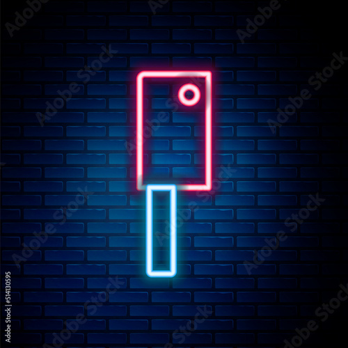 Billede på lærred Glowing neon line Meat chopper icon isolated on brick wall background