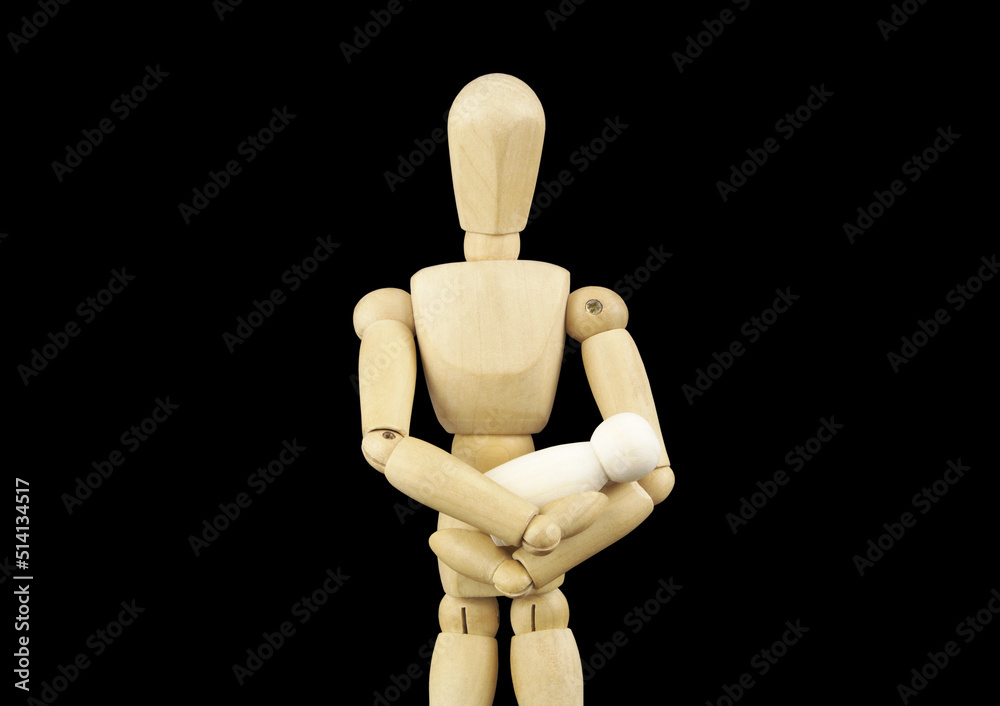 Parenthood and love concept. Wooden mannequin holding small baby figure isolated on black background. Parenthood and love concept. Wooden mannequin holding small baby figure isolated on black background.
