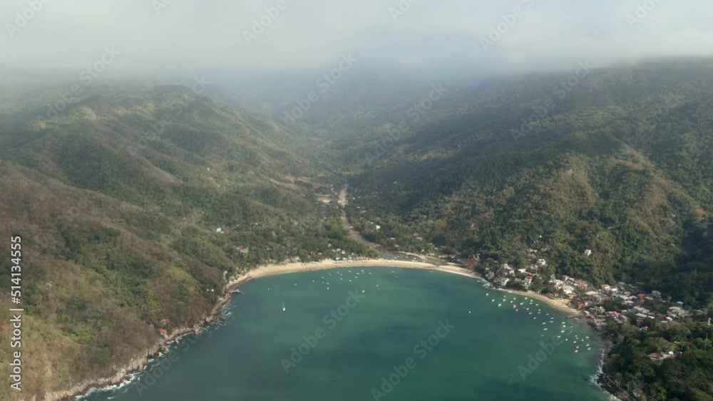 Panoramic View Of Resort Town And Lush Rainforest Under Misty Sky In Yelapa, Jalisco, Mexico. Aerial Wide Shot Panoramic View Of Resort Town And Lush Rainforest Under Misty Sky In Yelapa, Jalisco, Mexico. Aerial Wide Shot