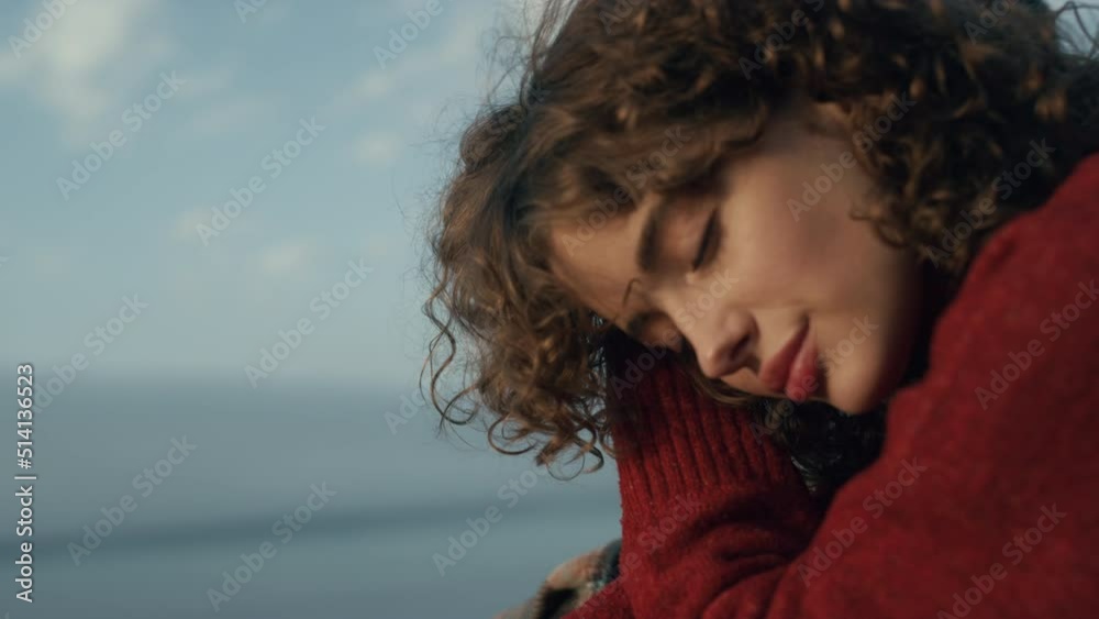Closeup glamour girl sitting on sea beach. Romantic woman enjoying leisure time Closeup glamour girl sitting on sea beach. Romantic woman enjoying leisure time