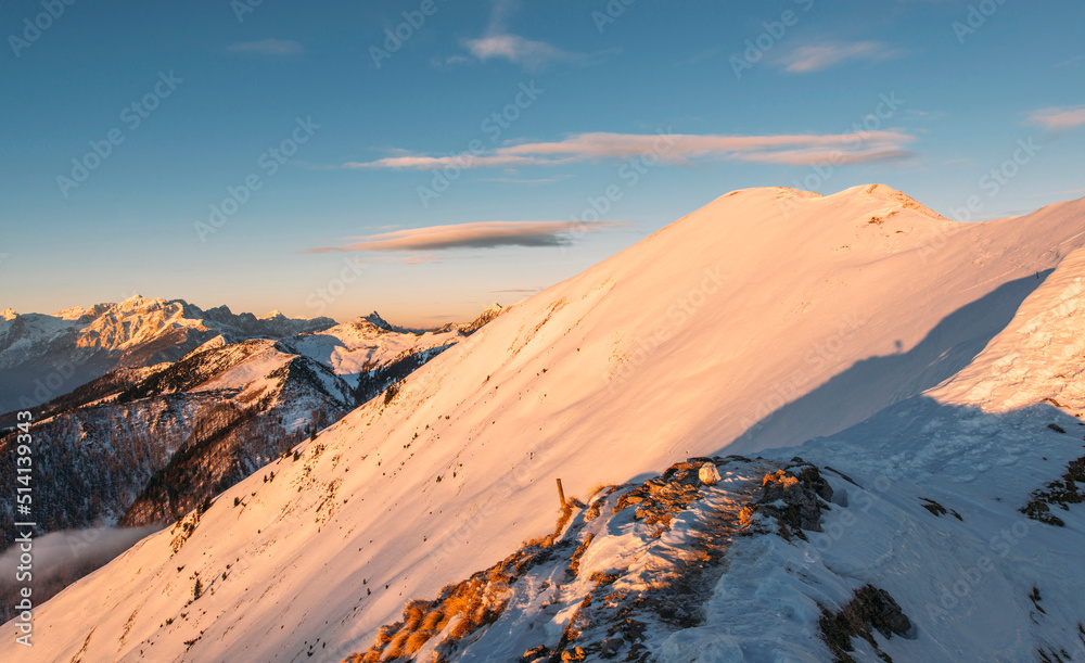 Fototapeta premium Winter peaks with fresh snow and clouds above it.