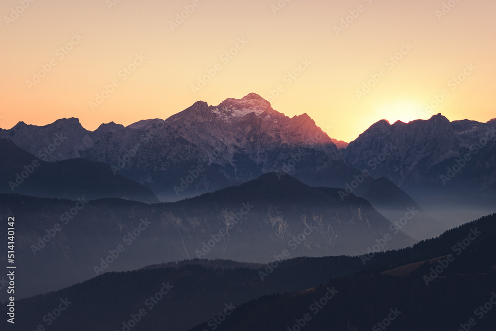 Foggy sunset in the mountains. Mist is covering the hills in the early evening.