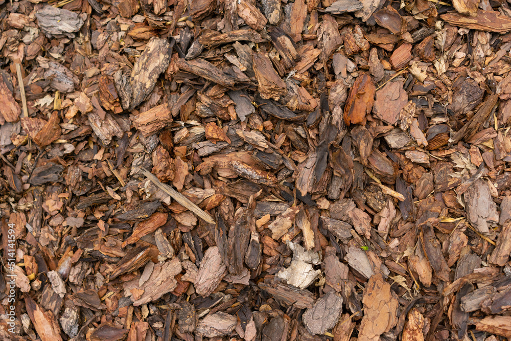 Pine Bark Mulch. A pile of wood chips to be used as landscaping mulch Pine Bark Mulch. A pile of wood chips to be used as landscaping mulch