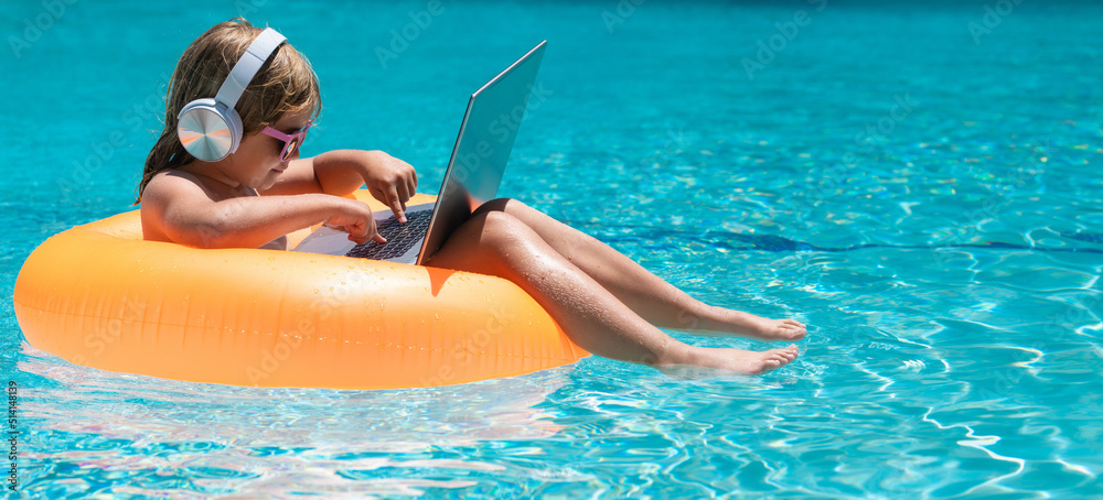 Little business man relaxing in the pool with laptop. Kid online working on  laptop, swimming in a sunny turquoise water pool. Stock-Foto | Adobe Stock