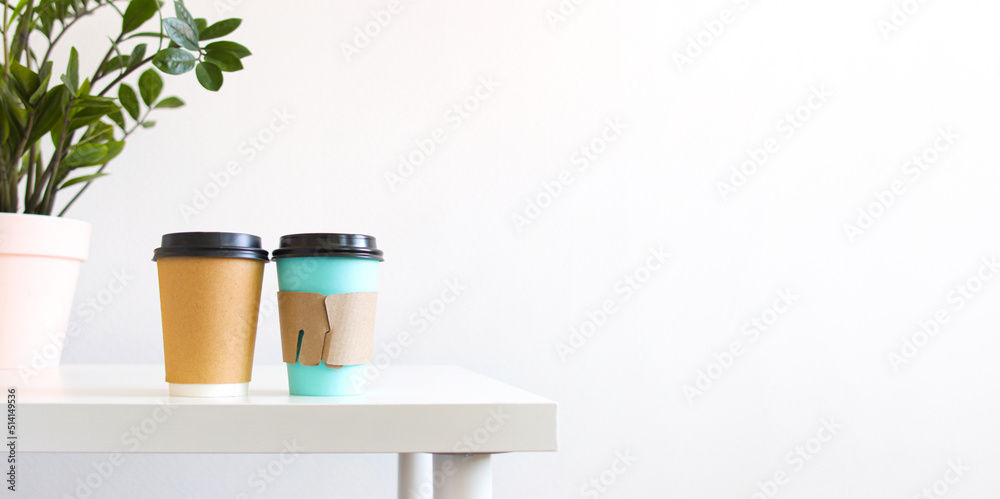 two cardboard cup of hot drink for take away on white table. Concept break, drinking coffee with friends, morning ritual, copyspace, banner two cardboard cup of hot drink for take away on white table. Concept break, drinking coffee with friends, morning ritual, copyspace, banner