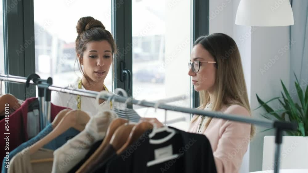 Video of two fashion designers working and deciding details of new collection of clothes in the sewing workshop. Video of two fashion designers working and deciding details of new collection of clothes in the sewing workshop.