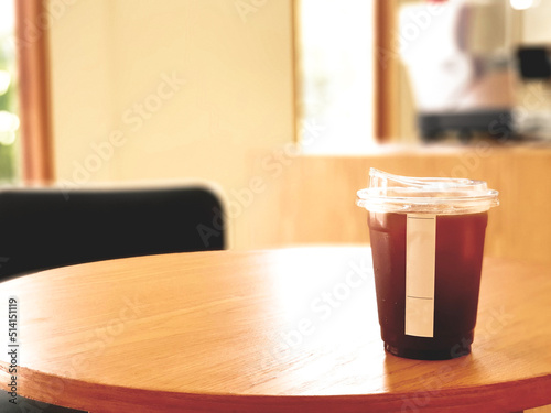 Ice coffee, americano coffee with orange in cafe.