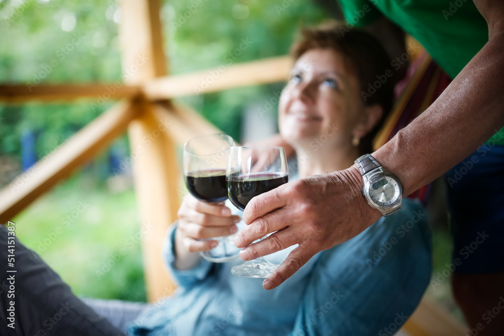 couple woman and man drinking red wine from glasses outside together couple woman and man drinking red wine from glasses outside together
