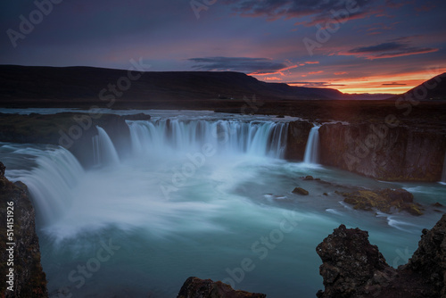 Stunning sunset over Godafoss Waterfall with smooth flowing in Iceland