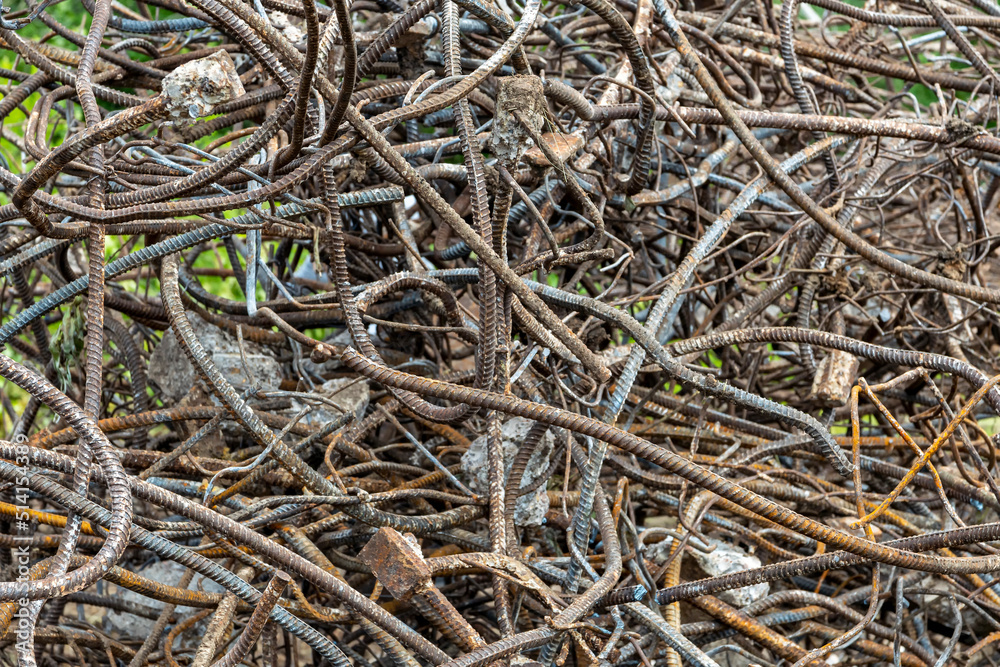 A textured surface of twisted rebar and wire that is piled into a large pile. A textured surface of twisted rebar and wire that is piled into a large pile.
