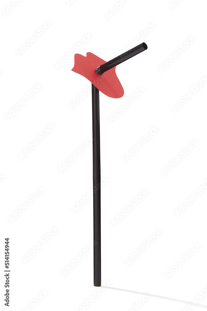 Close-up shot of a black corrugated curved straw with a red lip decoration. The drinking straw is isolated on a white background. Front view. Close-up shot of a black corrugated curved straw with a red lip decoration. The drinking straw is isolated on a white background. Front view.