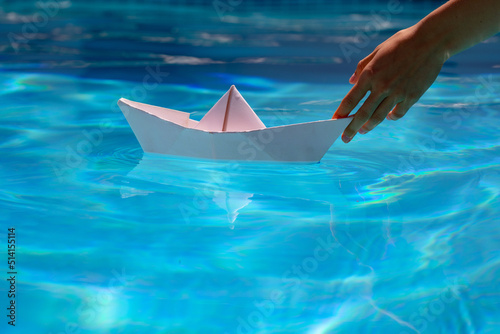 Paper ship in hand. Tourism and traveling  travel dreams vacation holiday  sailing adventure. Hand and paper boat.