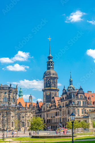 Cityscape over historical and touristic center in Dresden downtown, old clock tower near Cathedral of Holy Trinity and theater square, Dresden, Germany, at summer sunny day and blue sky.