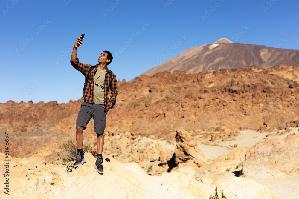 Young man taking selfie photo on a road trip. Man making memories on the mountain...