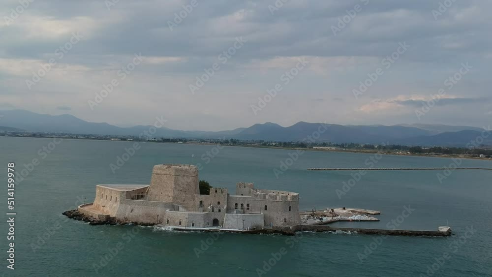 The famous Bourtzi, a Venetian water fortress at the entrance of the harbour in Nafplio seaside city in Argolis, Peloponnese, Greece. The famous Bourtzi, a Venetian water fortress at the entrance of the harbour in Nafplio seaside city in Argolis, Peloponnese, Greece.