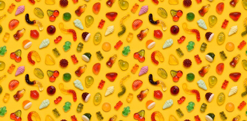 Seamless pattern of assorted gummies jelly gummy fruit sweets candy on yellow background top view flat lay