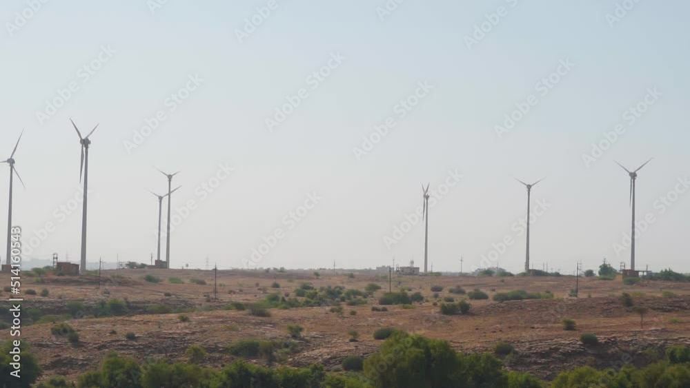 Windmills in a windfarm as seen from the Bada Bagh at Jaisalmer in Rajasthan, India. Wind Power Turbines Generating Clean Renewable Energy for Sustainable Development. Concept of using clean energy. Windmills in a windfarm as seen from the Bada Bagh at Jaisalmer in Rajasthan, India. Wind Power Turbines Generating Clean Renewable Energy for Sustainable Development. Concept of using clean energy.